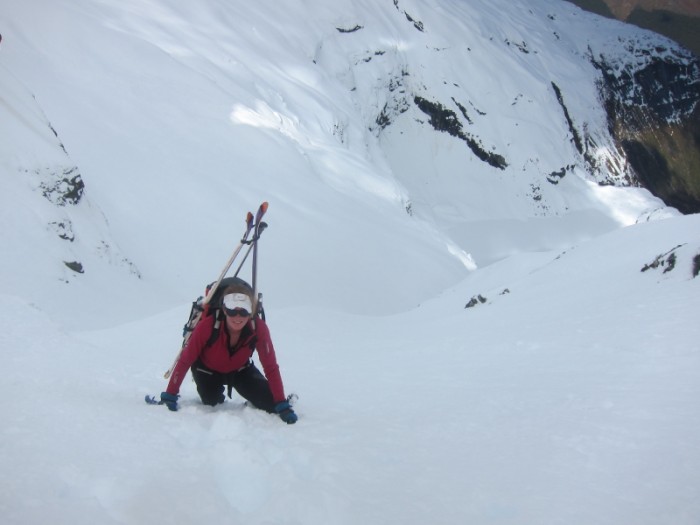 Chris bootpacking up above the glacial lake of Mt Clarke